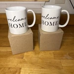Set 2 Welcome Home Coffee Mugs White & Black New With Box. Fixed Price $16.24.